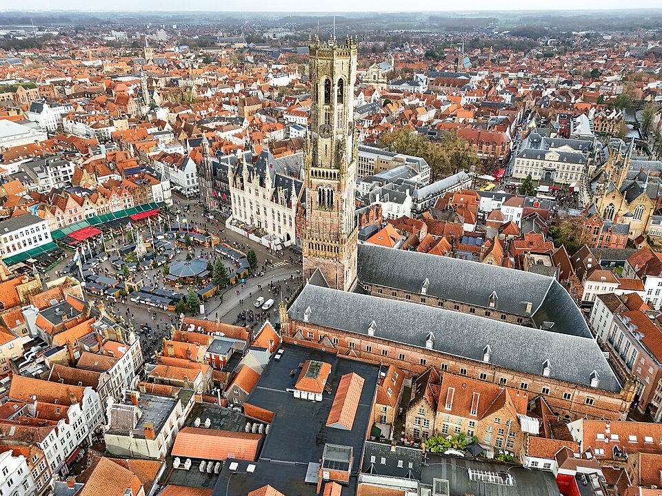 The Belfry and the long roof of the market halls from above, the Markt beside them
