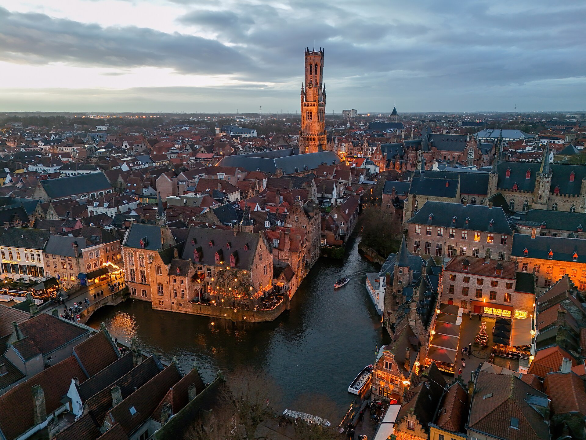 The Dijver canal and the Belfry of Bruges seen from above at dusk