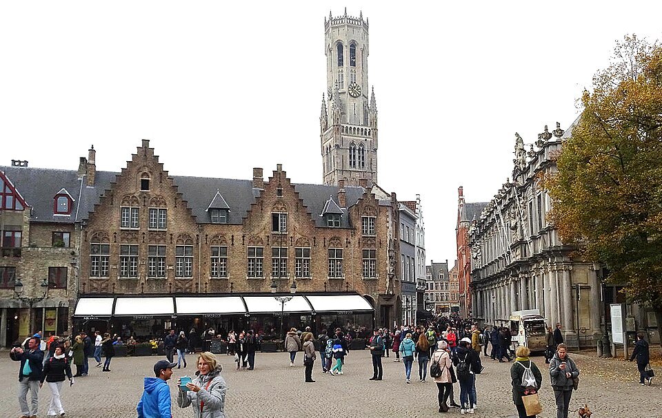 Crowds on the Burg with the Belfry rising behind the gables