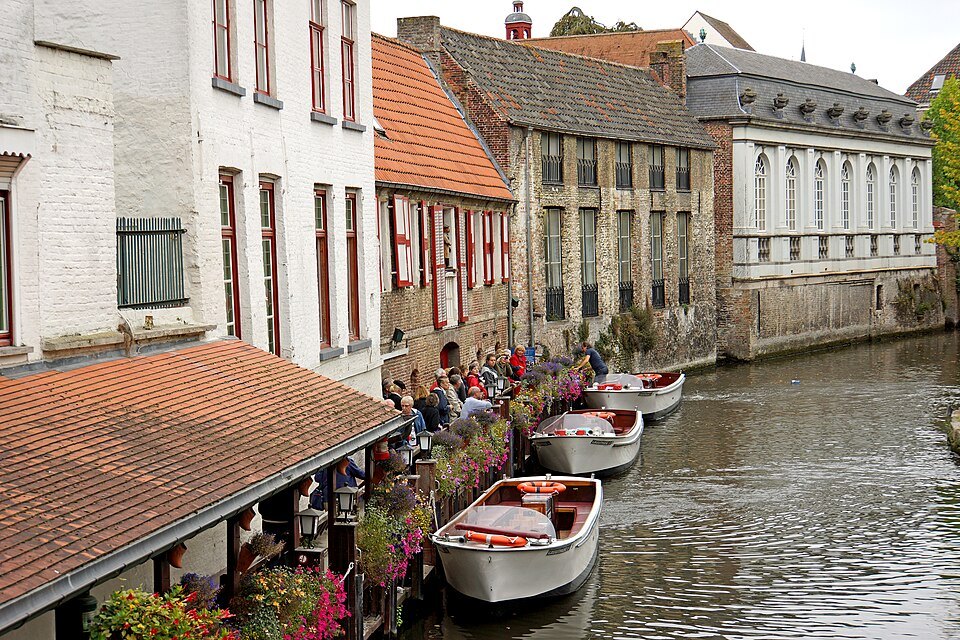 Empty boats moored beside a flower-decked terrace