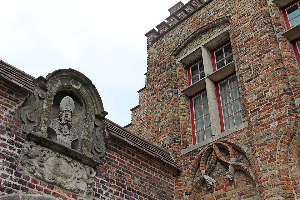 A carved stone bust set into a brick gable at the Arentshof