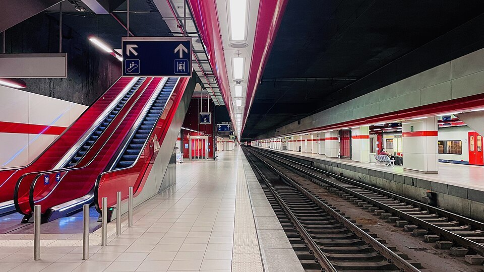 Red escalators down to the tracks at Brussels Airport station
