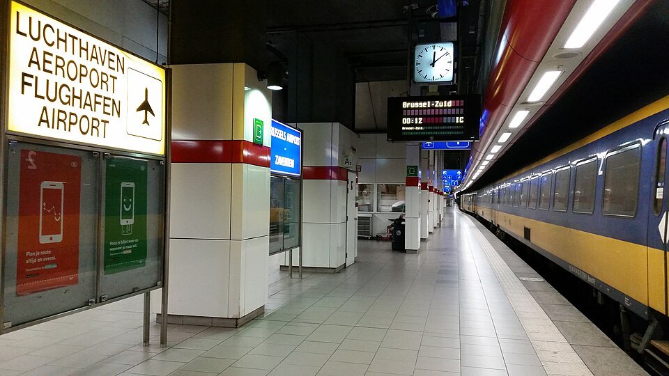Airport signs above the platforms of the station beneath Brussels Airport