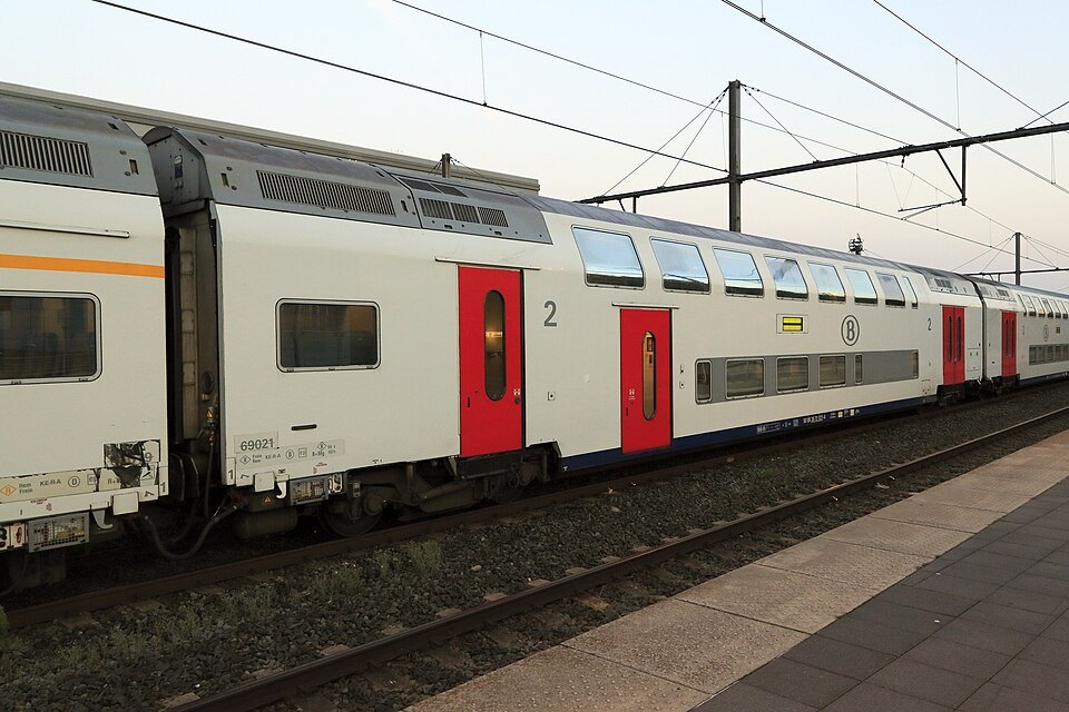 A double-deck train at a platform in Brugge