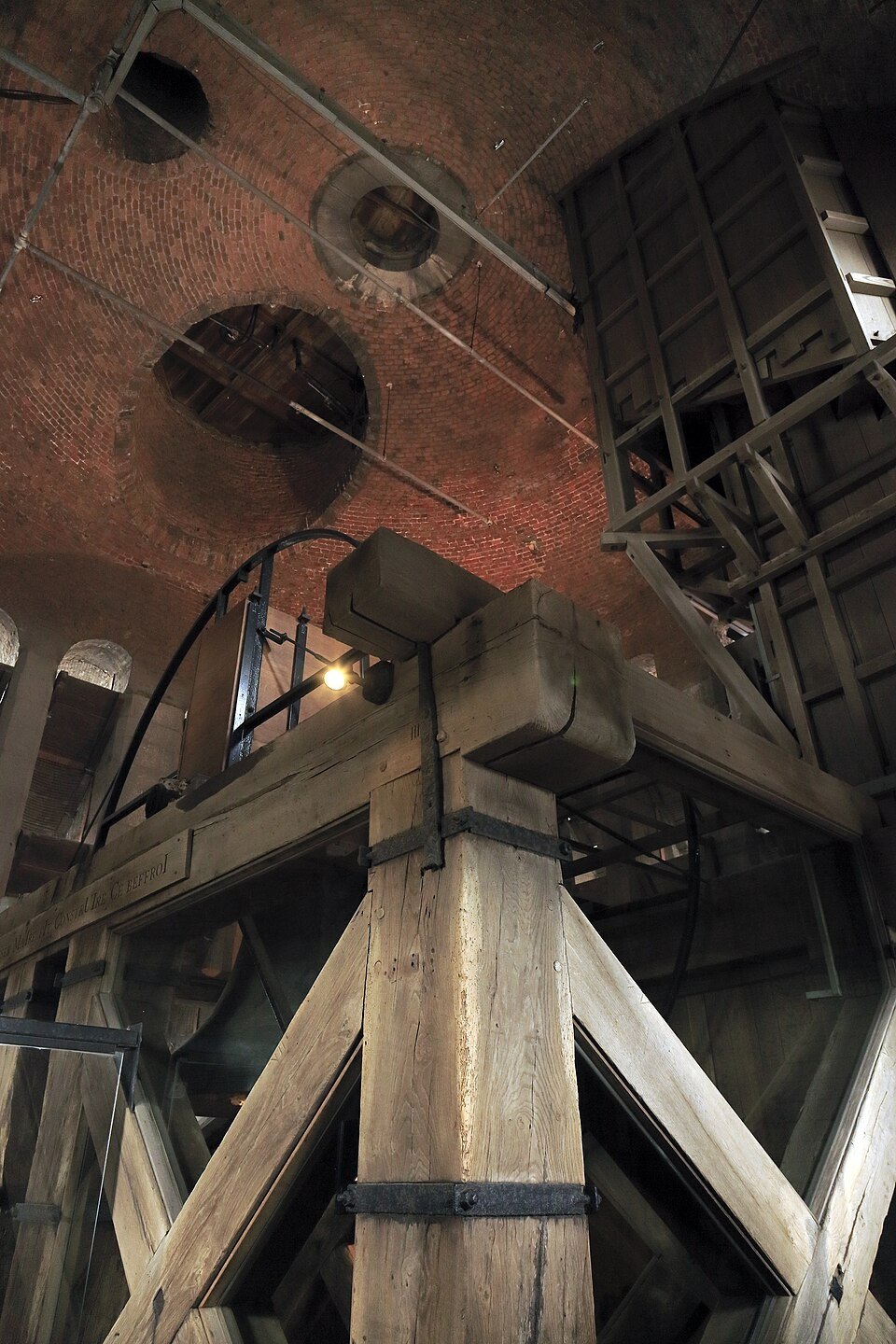 A large bell in its timber frame in the Belfry