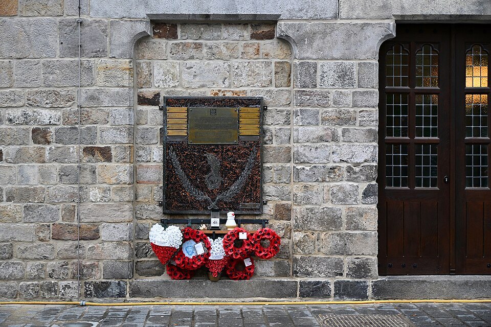 Poppy wreaths at a memorial on the Cloth Hall in Ypres
