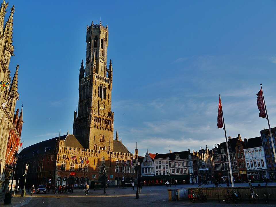 The Belfry lit by evening sun over the Markt