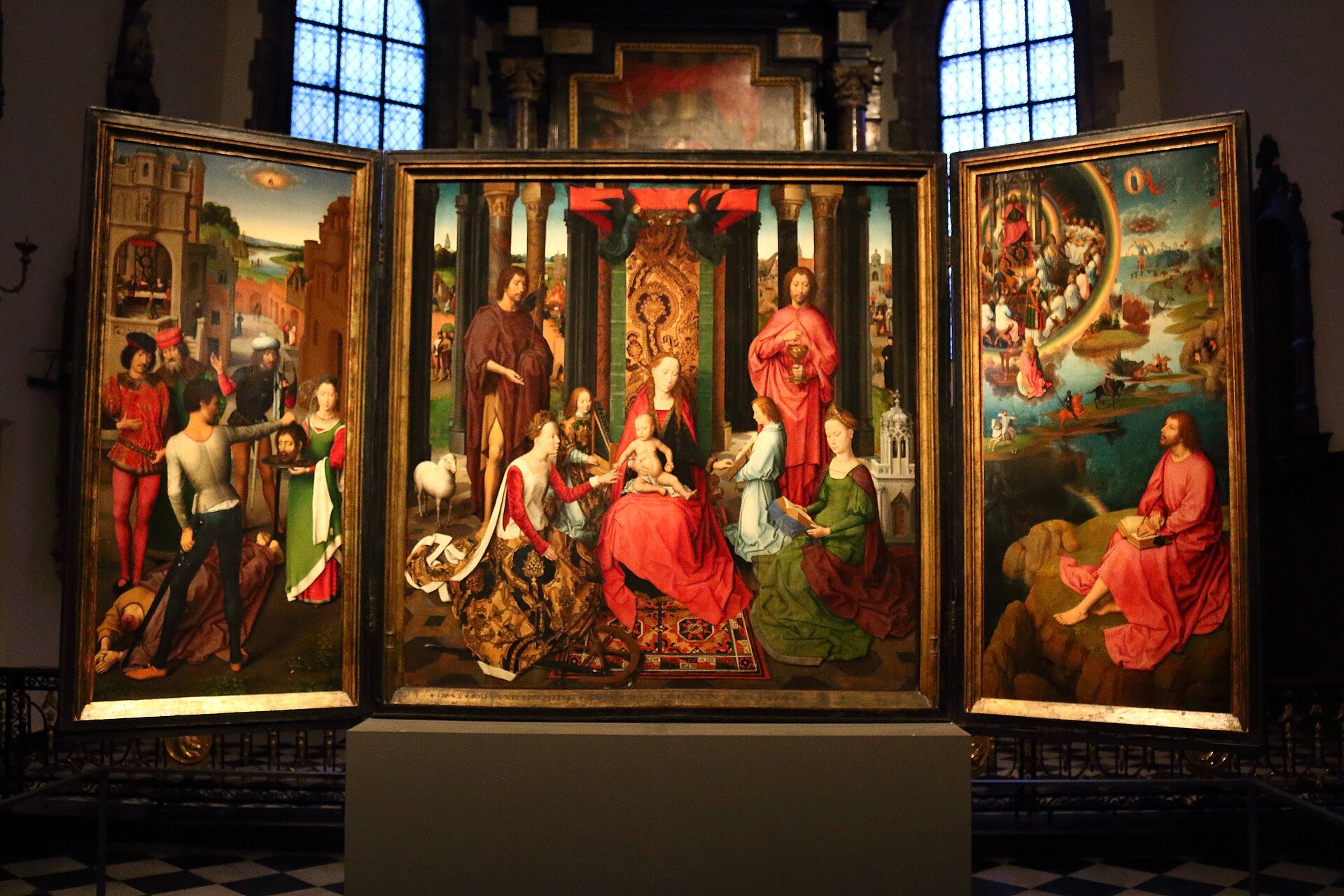 A Memling triptych displayed in a dark room of the hospital museum