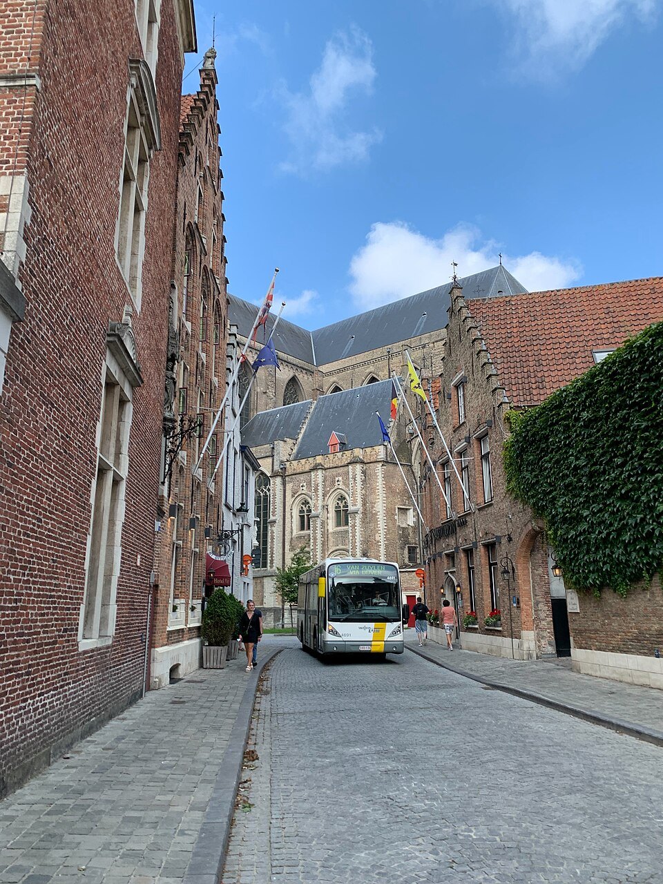 A De Lijn bus in a narrow brick street near St. Salvator's