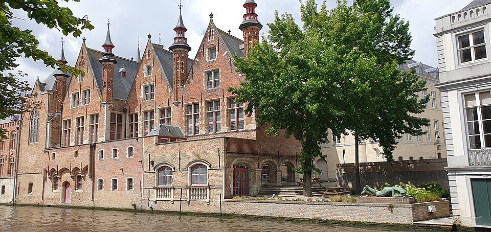 The brick back of the Liberty of Bruges rising from the canal