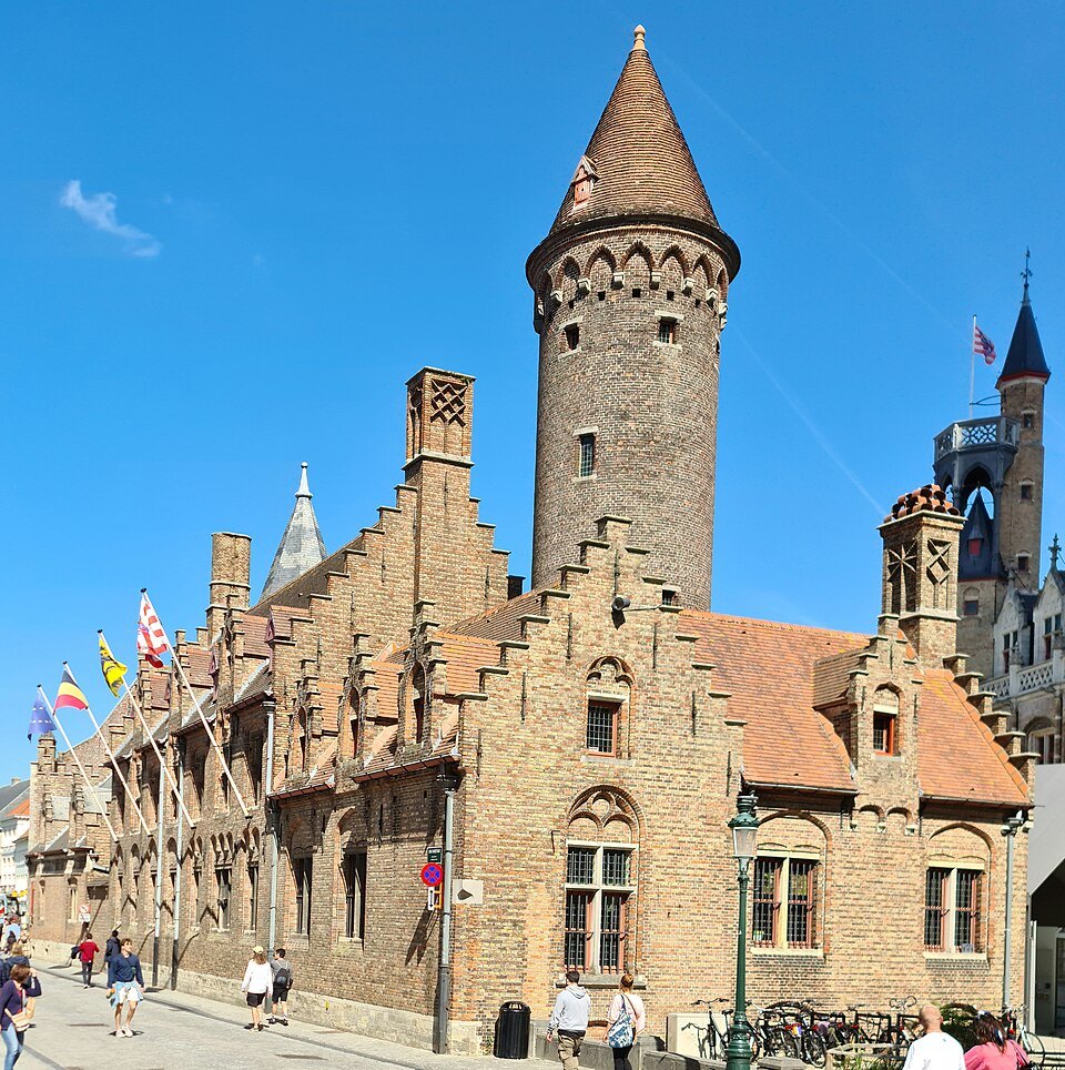 The palace's brick street front with its tall tower and flags