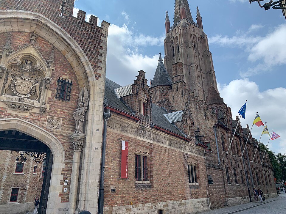The arched gateway on the street, the tower of Our Lady beyond