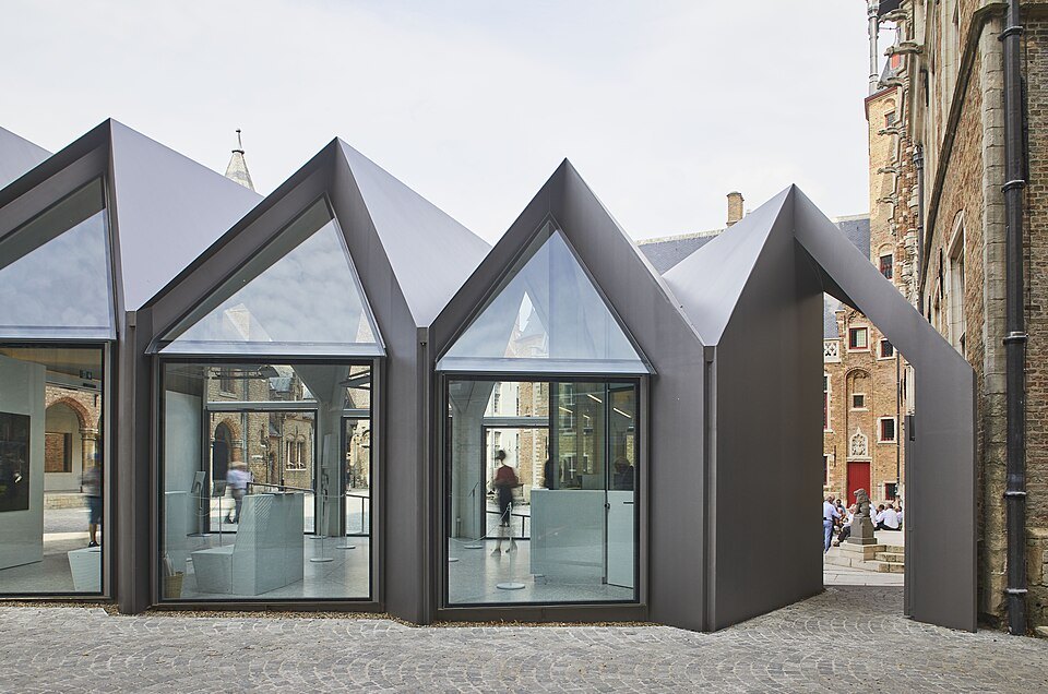 The modern glass pavilion in the courtyard, with its row of pointed roofs