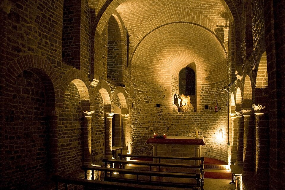 The low Romanesque lower chapel, lit above its altar