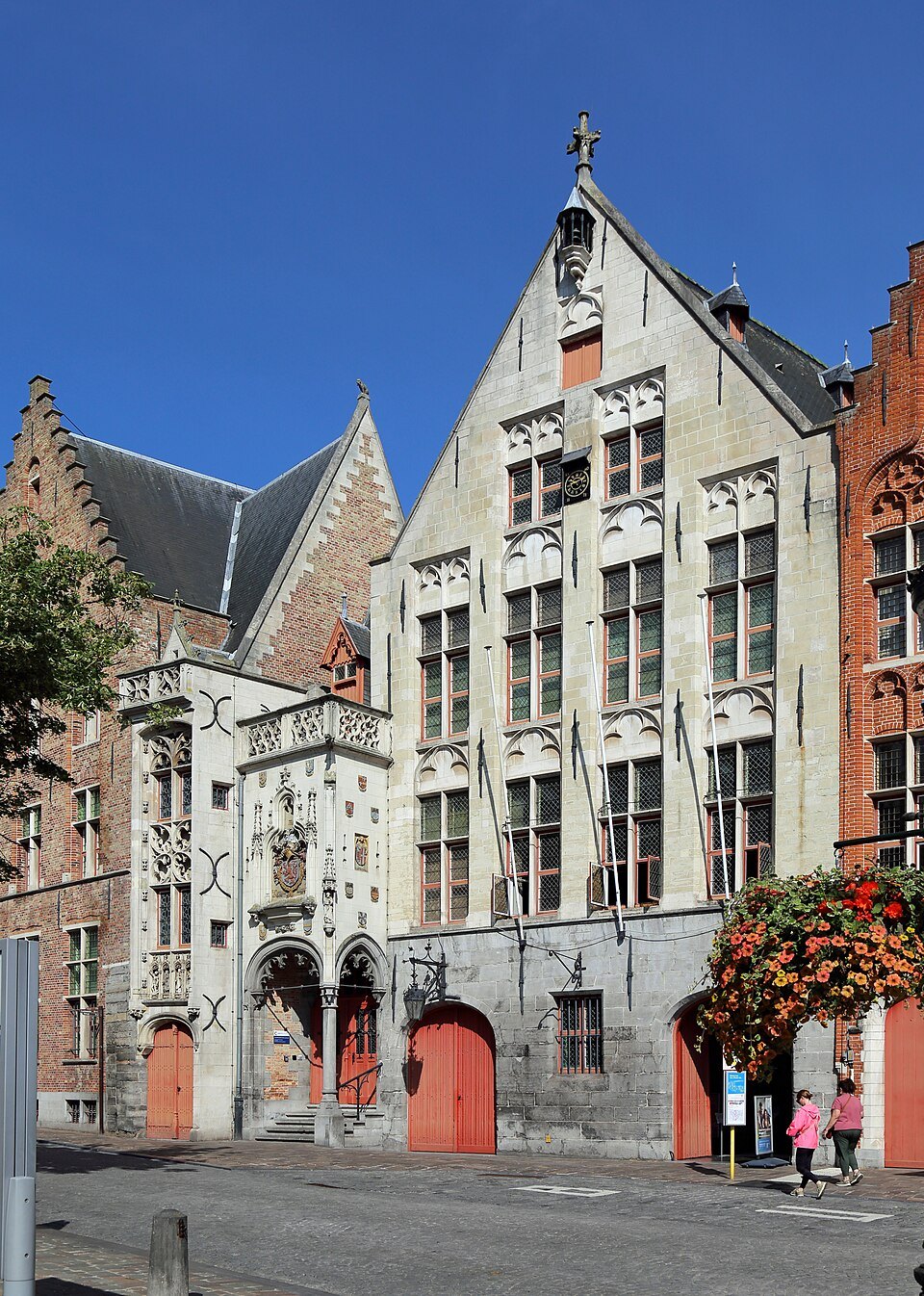 The old toll house with its stepped gable and red doors on the square
