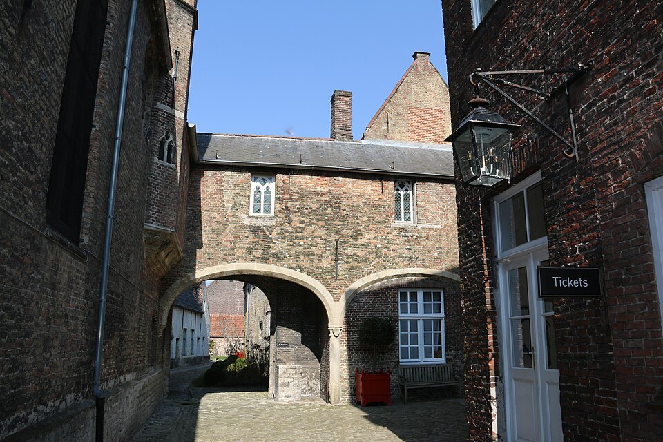 A brick archway through the buildings of the Adornes estate