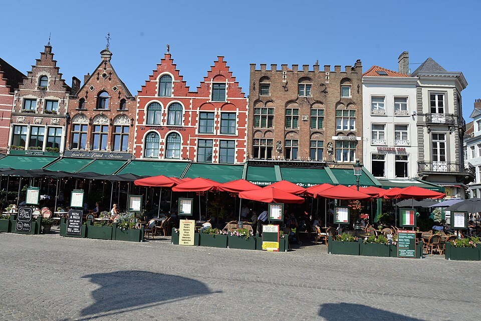 The row of gabled houses on the north side, café terraces below