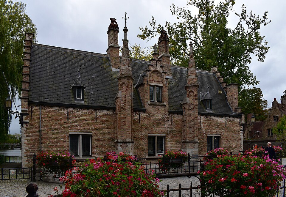 The brick Sas House with flower beds in front