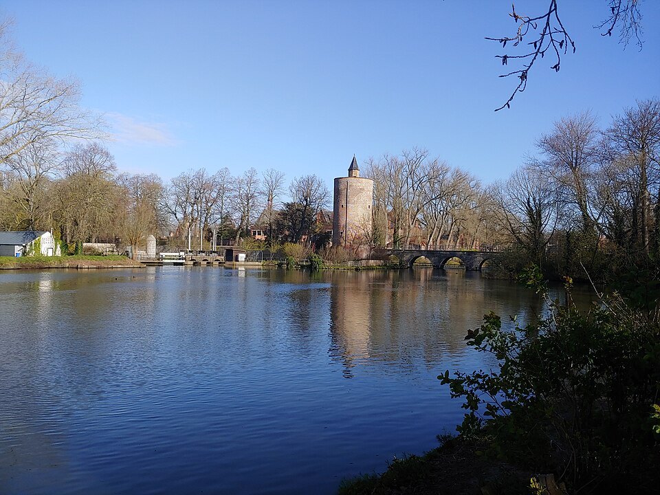 The brick Poertoren at the far end of the water under a pale winter sky