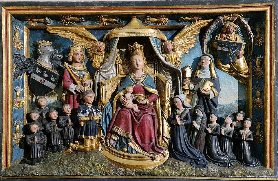 A painted and gilded late Gothic relief of the Virgin with kneeling donors