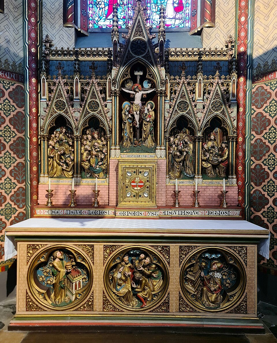 A Gothic altar with carved and gilded panels in a side chapel