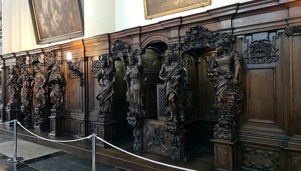 Carved wooden confessionals lining a wall of the church