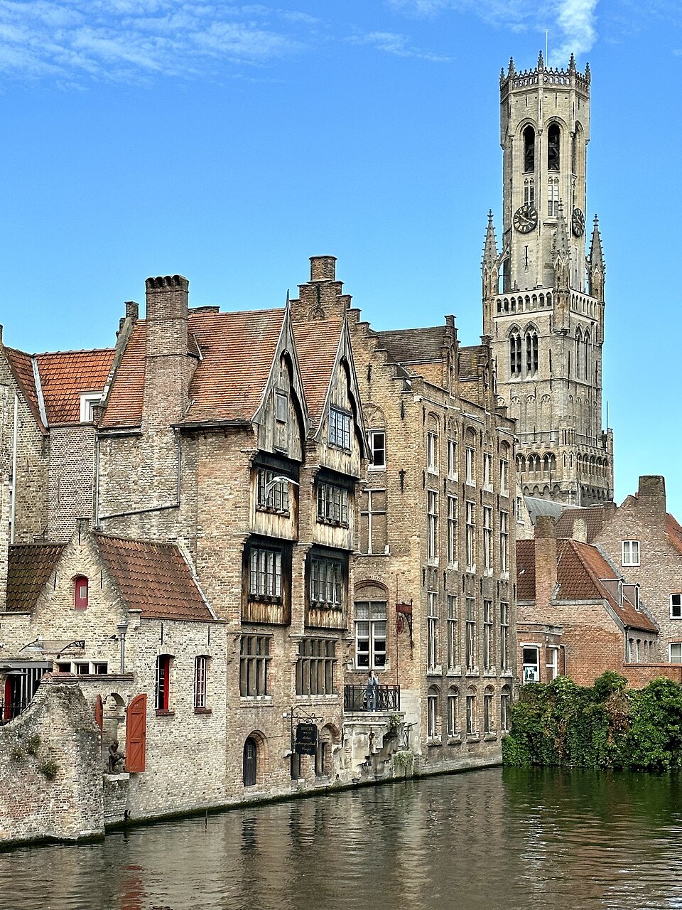 The Belfry rising above the canal-side houses of the Rozenhoedkaai