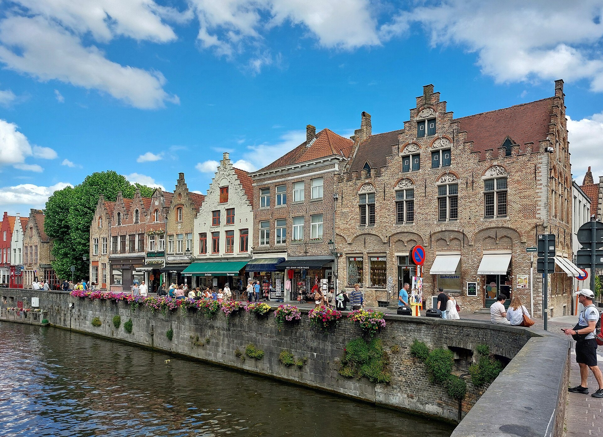Flower boxes along the quay wall of the Rozenhoedkaai, gabled houses beyond
