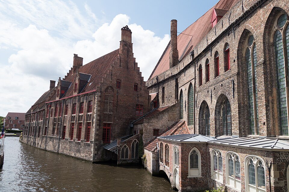 The hospital's stepped gables and long brick walls along the canal