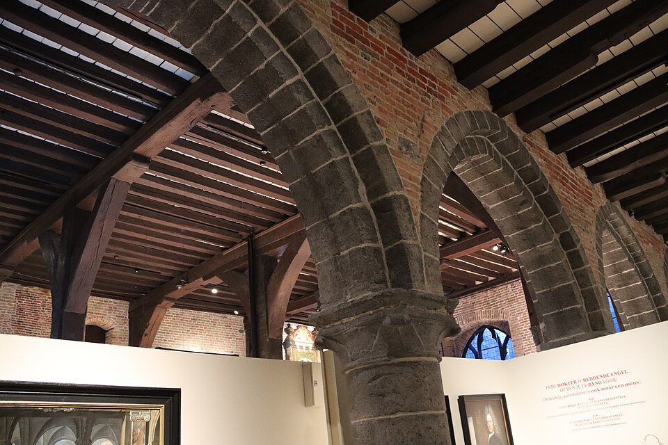 Stone arches and a timber roof over a ward of the museum