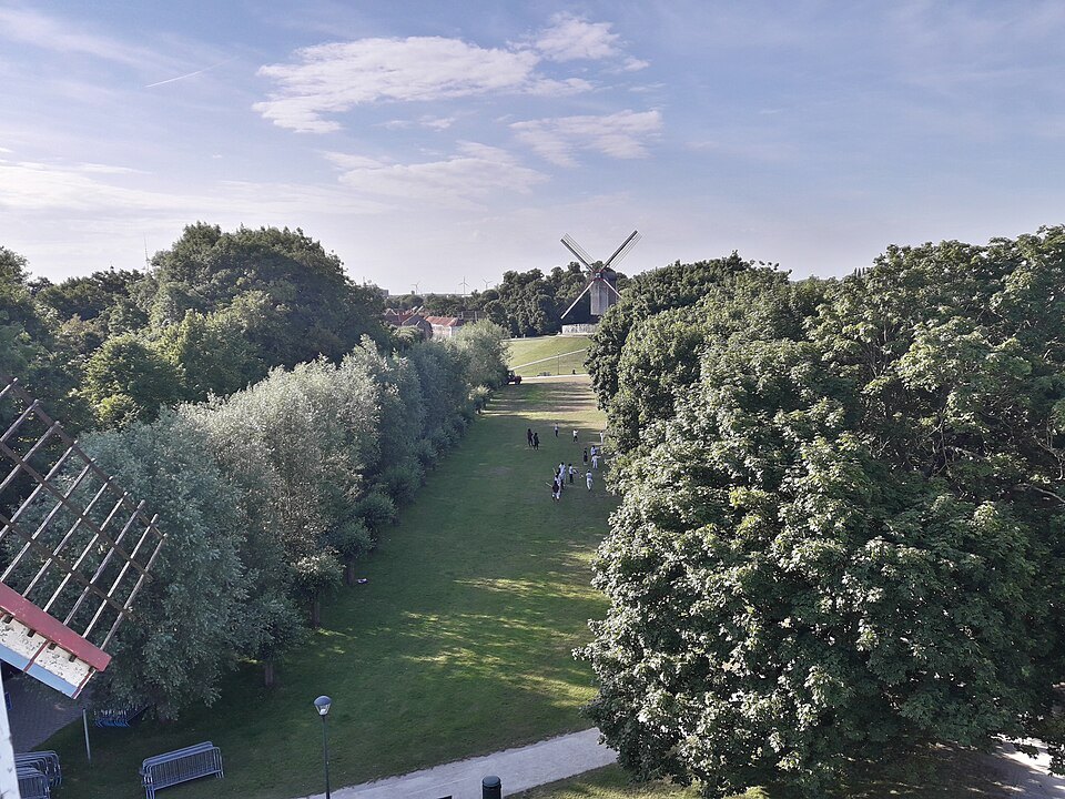 The green rampart path seen from above, a windmill in the distance